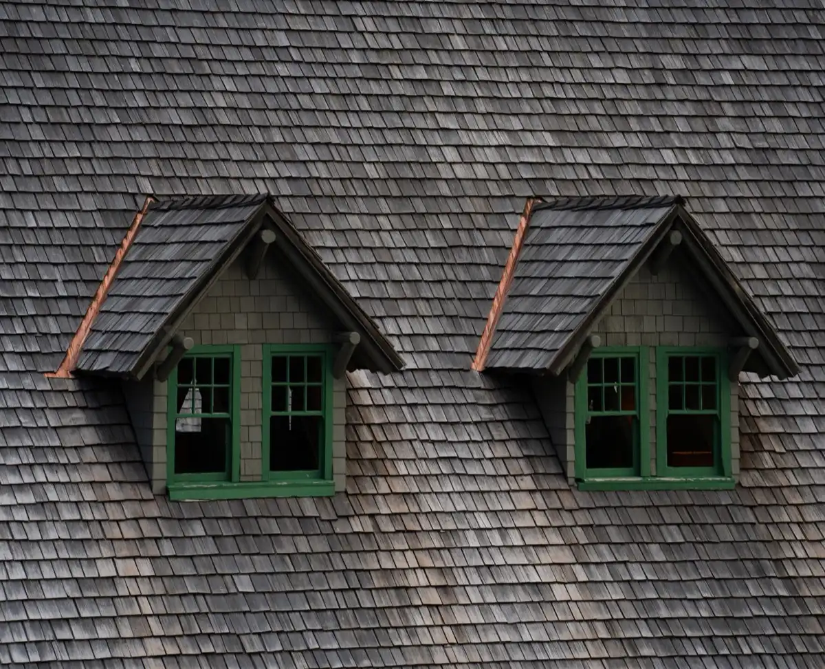 Dormers on a shingle roof in Metairie, LA, where step flashing and kickout flashing carry water past the walls